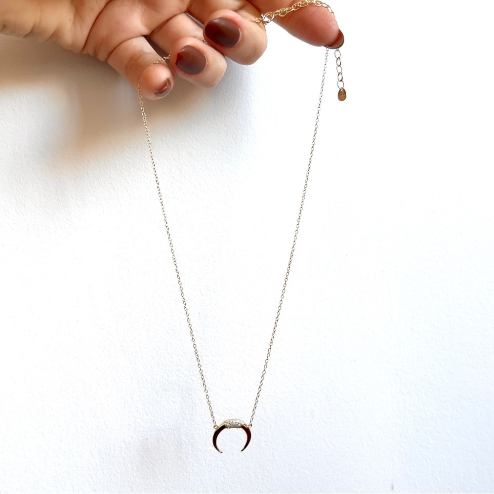 Gold tone crystal pave crescent pendant necklace